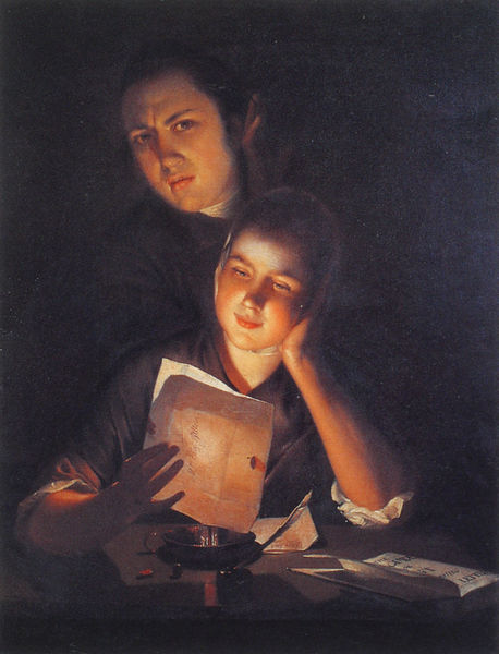 A girl reading a letter by candlelight, with a young man peering over her shoulder