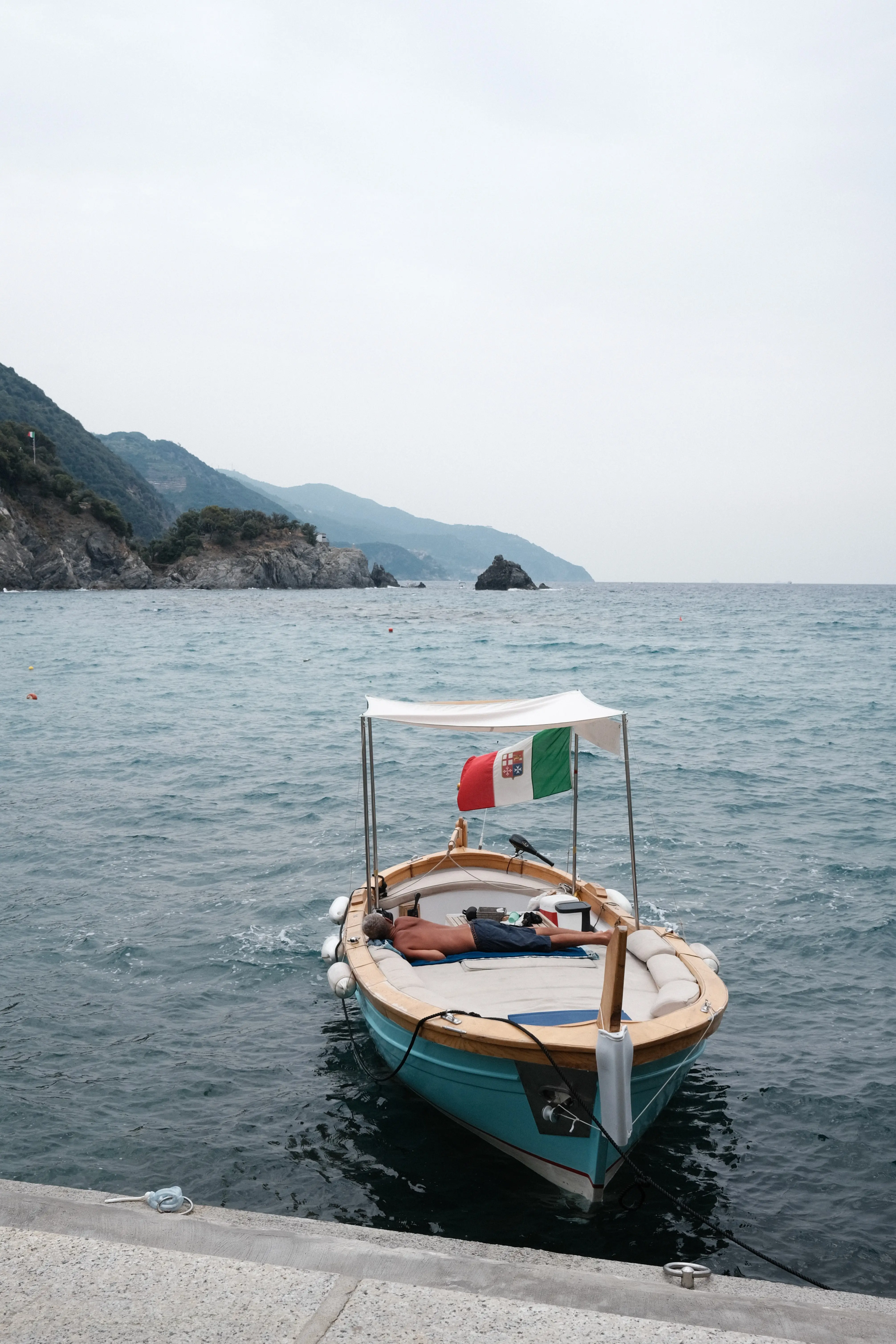 Photo: 2022-06-22_Man-Sleeping-on-Boat-in-Cinque-Terre.webp