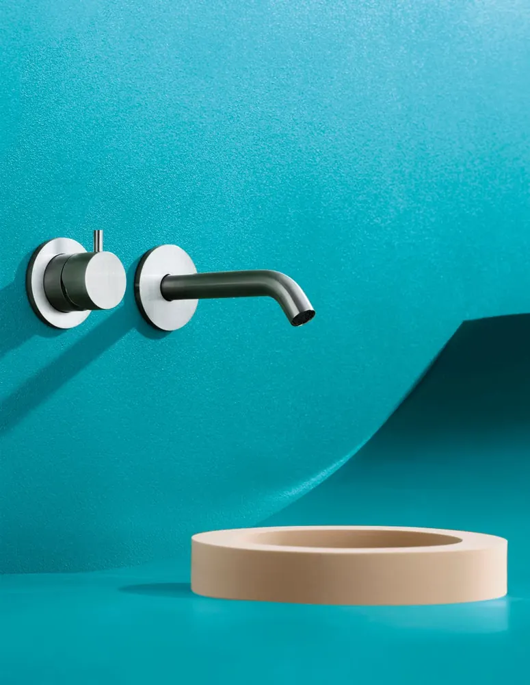 Fontea wall-mounted brushed steel tap above a shallow basin