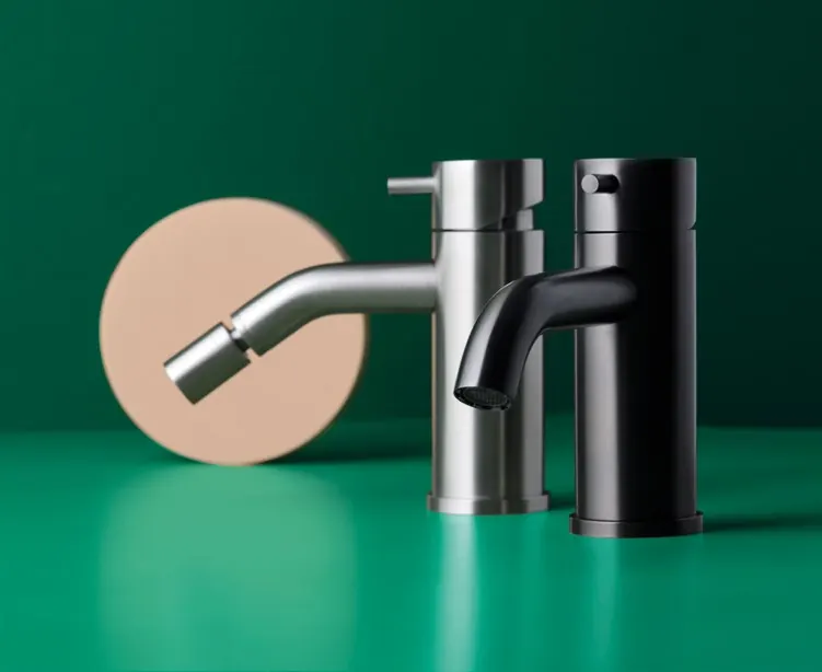 Fontea deep grey and brushed stainless steel fittings on a green surface