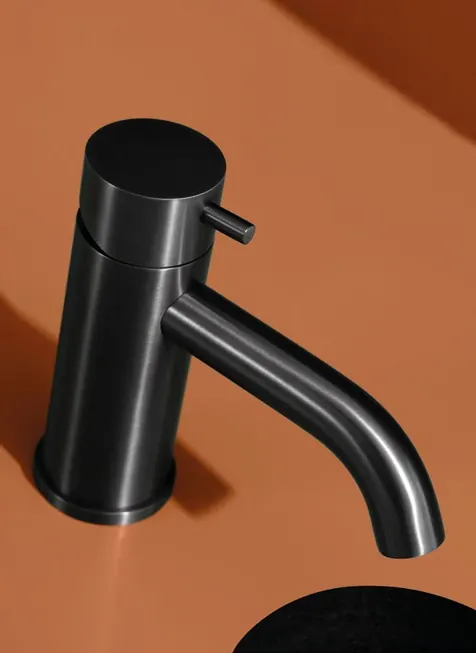 Fontea deep grey PVD tap against an orange backdrop
